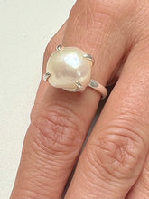 Close up of finger wearing Freshwater Pearl Ring in silver. 
