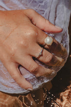 Model hand with Freshwater Pearl ring in the ocean.