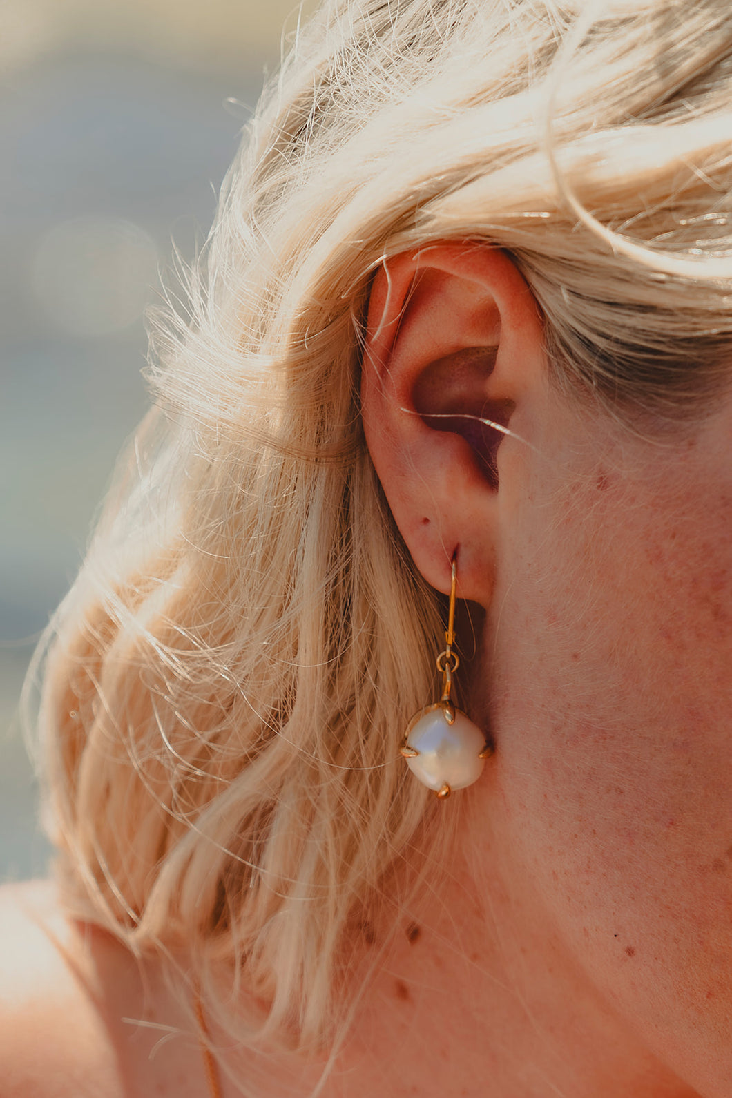 Close up shot of Freshwater Pearl Earrings in gold.
