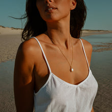 Model shot at the lagoon wearing gold Freshwater Pearl Necklace 