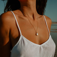 Close up shot of the Freshwater Pearl Necklace in gold.
