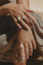 Close up shot of hands wearing Sea Goddess RIng