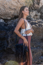 Model shot of the Midnight Drift Tassel Leather Bag, with the model wearing Herkimer Diamond rings, necklace, thread earrings and bangles in gold.