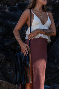 Model shot of the Midnight Drift Tassel Leather Bag, with the model wearing Herkimer Diamond rings, necklace, thread earrings and bangles in gold.