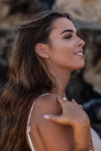 Close-up of model wearing Herkimer Diamond rings in gold with matching stud earrings.