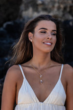 Close-up shot of the model wearing two Higher Realm Herkimer Diamond Crystal Necklaces in gold around her neck, paired with matching gold Herkimer Diamond stud earrings, showcasing the elegance and brilliance of the crystals.