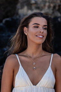 Close-up shot of the model wearing two Higher Realm Herkimer Diamond Crystal Necklaces in gold around her neck, paired with matching gold Herkimer Diamond stud earrings, showcasing the elegance and brilliance of the crystals.