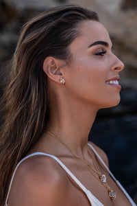 Close-up model shot of the Higher Realm Herkimer Diamond Stud Earrings in gold, showcasing the crystal clarity and radiant sparkle of the diamonds.