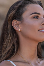 Close-up model shot of the Higher Realm Herkimer Diamond Stud Earrings in gold, showcasing the crystal clarity and radiant sparkle of the diamonds.