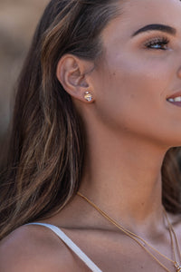 Close-up model shot of the Higher Realm Herkimer Diamond Stud Earrings in gold, showcasing the crystal clarity and radiant sparkle of the diamonds.