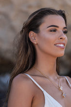 Model wearing two Higher Realm Herkimer Diamond Crystal Necklaces in gold around her neck, paired with matching stud earrings, showcasing the elegance and brilliance of the Herkimer diamonds.