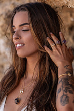 Close-up of the model wearing a gold Higher Realm Herkimer Diamond Crystal Necklace, paired with amethyst rings, an amethyst necklace, Herkimer Diamond rings, and a bangle, highlighting the natural beauty and elegance of the collection.