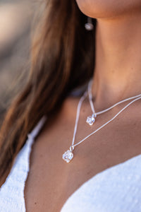 Very close-up of the model’s neck, wearing two Higher Realm Herkimer Diamond Crystal Necklaces in silver, showcasing the natural clarity and shine of the Herkimer diamonds.