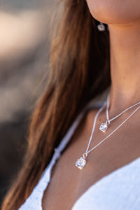 Very close-up of the model’s neck wearing two silver Higher Realm Herkimer Diamond Crystal Necklaces, showcasing the clarity and brilliance of the Herkimer diamonds.