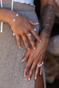 Close-up of the model’s hands wearing Higher Realm Herkimer Diamond rings in silver, paired with the matching Herkimer Diamond bangle, highlighting the elegance and shimmer of the diamonds.