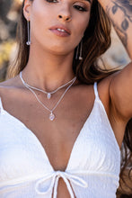 Close-up of the model wearing two silver Higher Realm Herkimer Diamond Crystal Necklaces, paired with silver Herkimer Diamond thread earrings, highlighting the brilliance and elegance of the Herkimer diamonds.