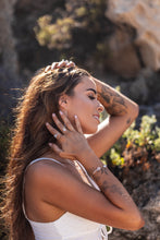 Model wearing Higher Realm Herkimer Diamond rings in silver, the matching Herkimer Diamond bangle, and thread earrings, with the sun glistening on the pieces, radiating beauty and elegance.