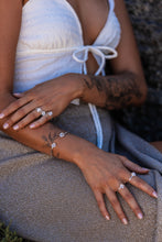 Close-up of the model wearing Higher Realm Herkimer Diamond rings and bangle in silver, highlighting the sparkling diamonds.