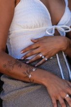 Close-up of the model wearing Higher Realm Herkimer Diamond rings and matching bangle, highlighting the sparkling diamonds and the refined silver setting.