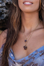 Close-up of a model wearing two Violet Horizon Amethyst Crystal Necklaces in gold—one large and one small—highlighting their raw, natural beauty.