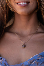 Close-up of model wearing the small Violet Horizon Amethyst Crystal Necklace in gold, showcasing the raw, hand-dug amethyst against her skin.