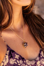 Close-up of the model’s neck wearing the Twilight Veil Amethyst Crystal Cluster Necklace in gold, showcasing the raw amethyst clusters and intricate design.