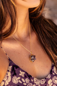 Close-up of the model’s neck wearing the Twilight Veil Amethyst Crystal Cluster Necklace in gold, showcasing the raw amethyst clusters and intricate design.