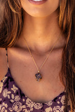 Close-up of the model wearing the Twilight Veil Amethyst Crystal Cluster Necklace in gold around her neck, focusing on the raw amethyst clusters and intricate design.