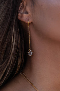 Close-up shot of the model wearing Herkimer Diamond thread earrings in gold.