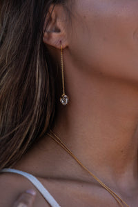 Close-up shot of the model wearing Herkimer Diamond thread earrings in gold.