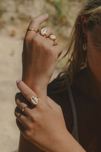 Close up shot of model's hands wearing Sea Goddess Ring in gold. 