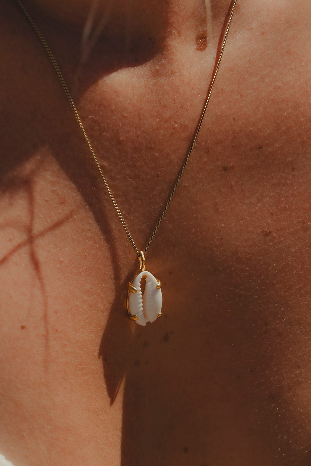 Close up of model wearing the Sea Goddess Necklace in gold. 